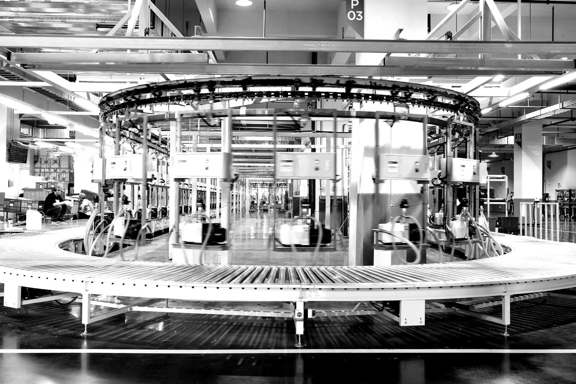 a large machine in a factory with people working on it