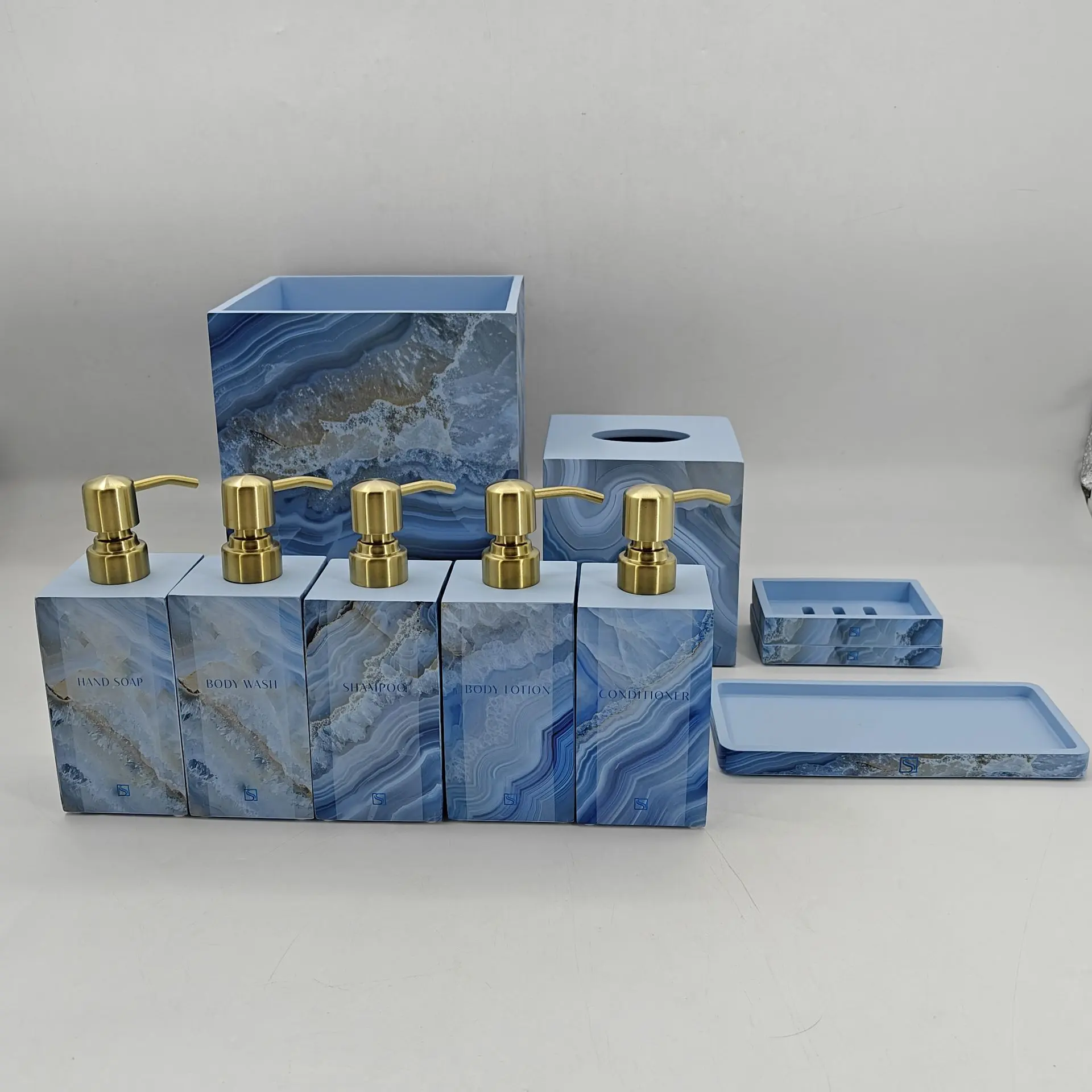 9-piece blue agate pattern bathroom accessory set with gold soap dispensers, tissue box cover, wastebasket, soap dish, and vanity tray.