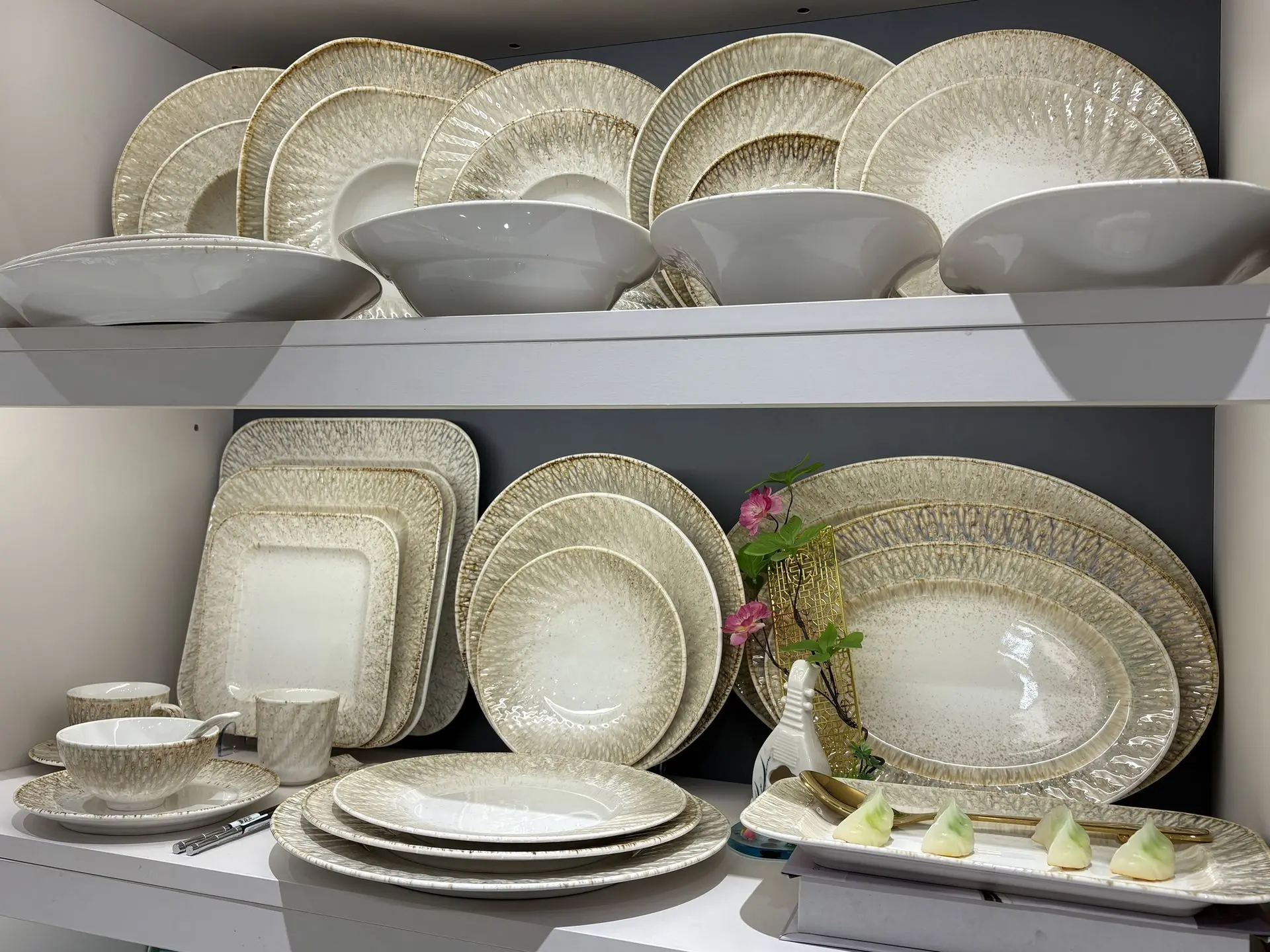 Luxury Chinese Ceramic Dinnerware Set with Golden Radial Design A comprehensive display of elegant Chinese porcelain dinnerware featuring a textured golden sunburst pattern on white ceramic plates, bowls, and serving platters.