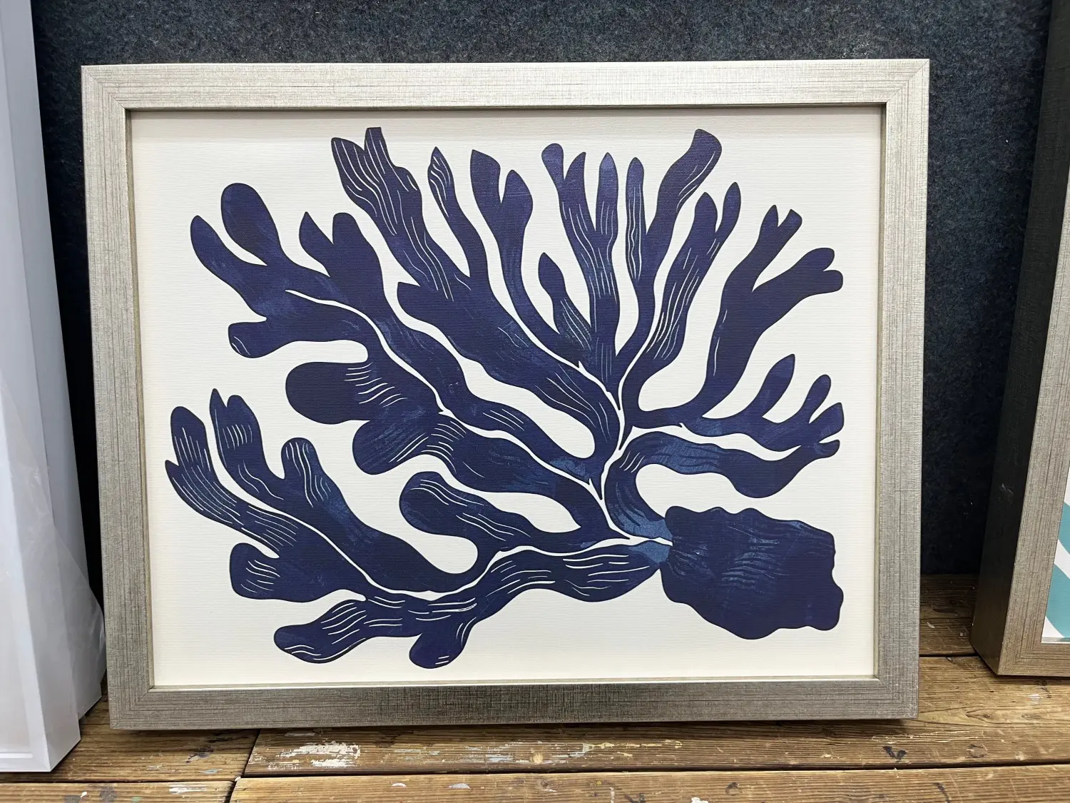 Framed Coastal Coral Wall Art - China Blue Botanical Print Navy blue coral seaweed art print in a silver frame, featuring a botanical silhouette in a classic China blue color palette.