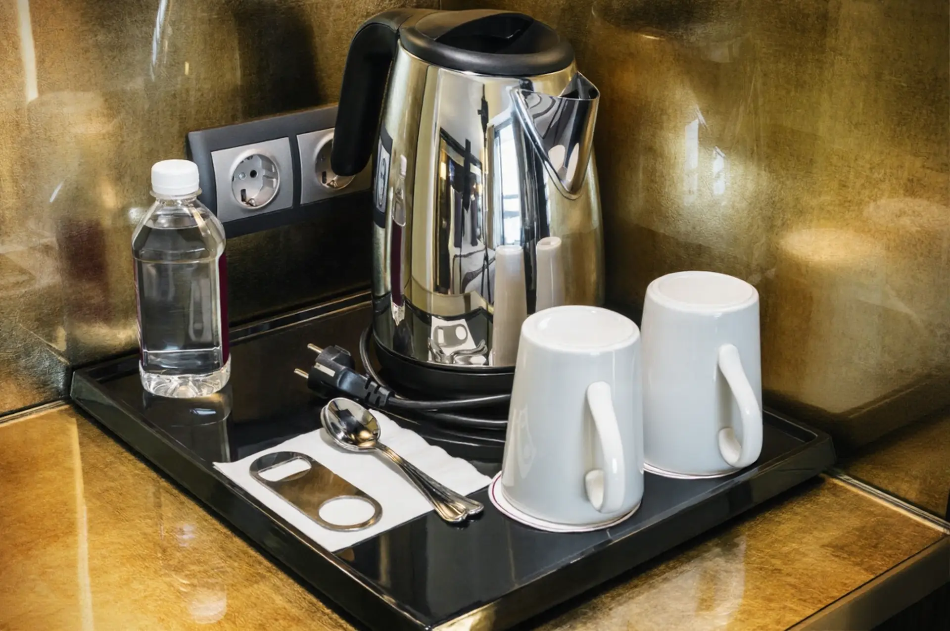 Luxury hotel in-room tea station featuring a modern electric kettle and ceramic tea set, highlighting premium OS&E in China for hospitality procurement.