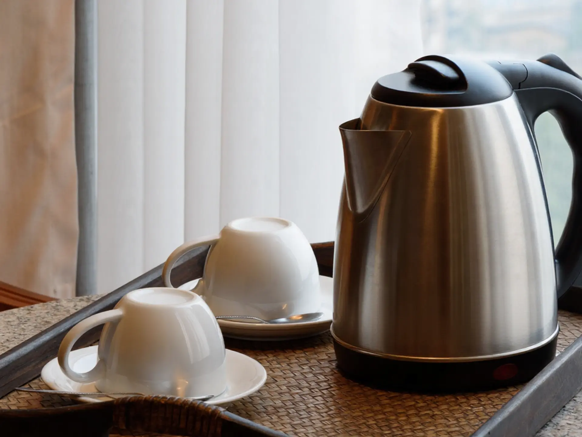 Tag	A hotel room tea set on a wooden tray featuring a stainless steel electric kettle and two white ceramic cups, representing typical OS&E from China for a 200-room hotel.