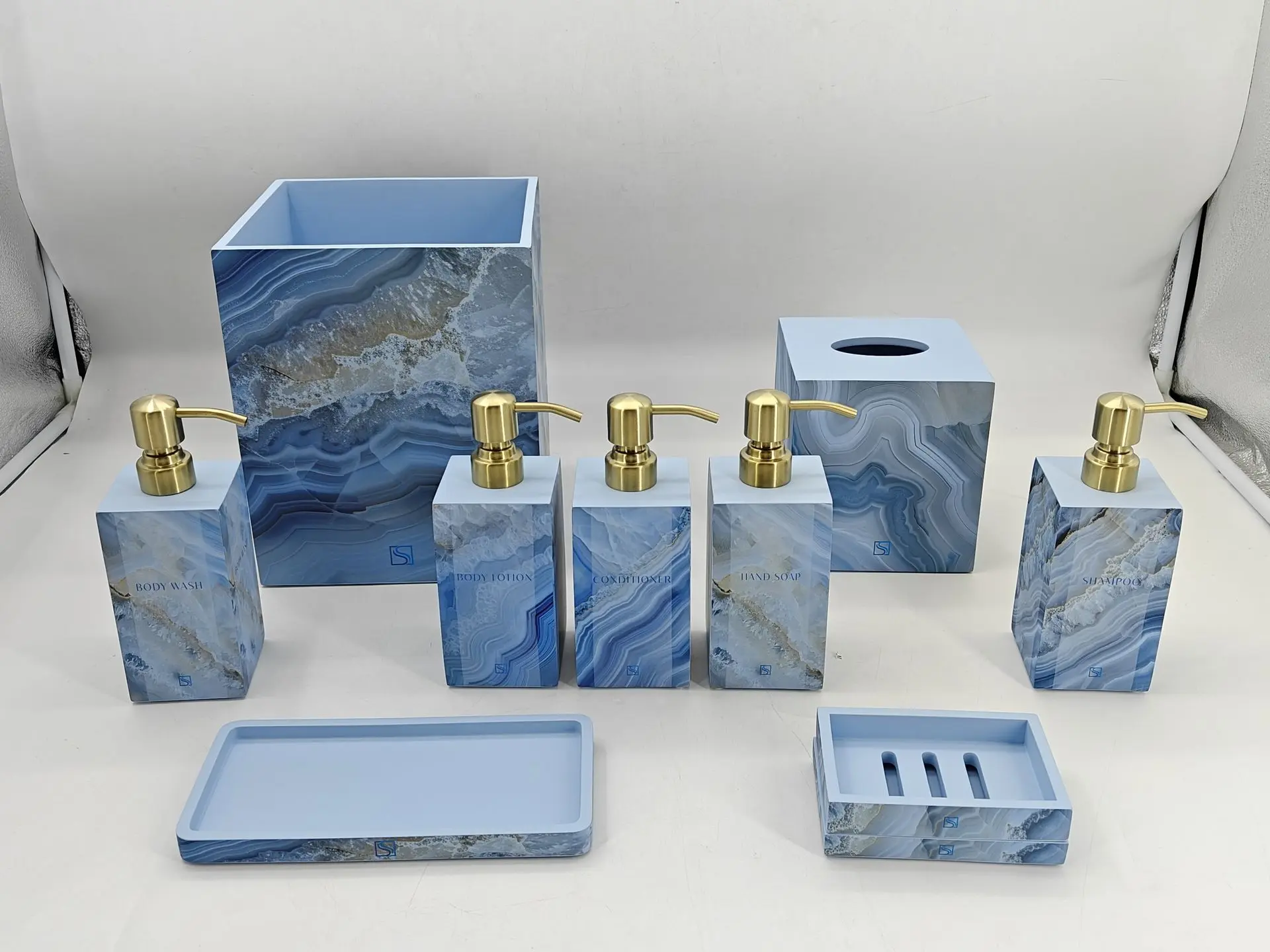 Luxury blue agate pattern guestroom bathroom accessory set with gold soap dispensers, tissue box, and wastebasket, manufactured in China.