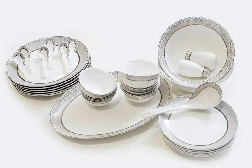 Elegant 45-piece fine bone china OS&E collection featuring white porcelain with silver textured rims, including dinner plates, soup bowls, serving platters, and spoons for hotel and restaurant tabletop service.