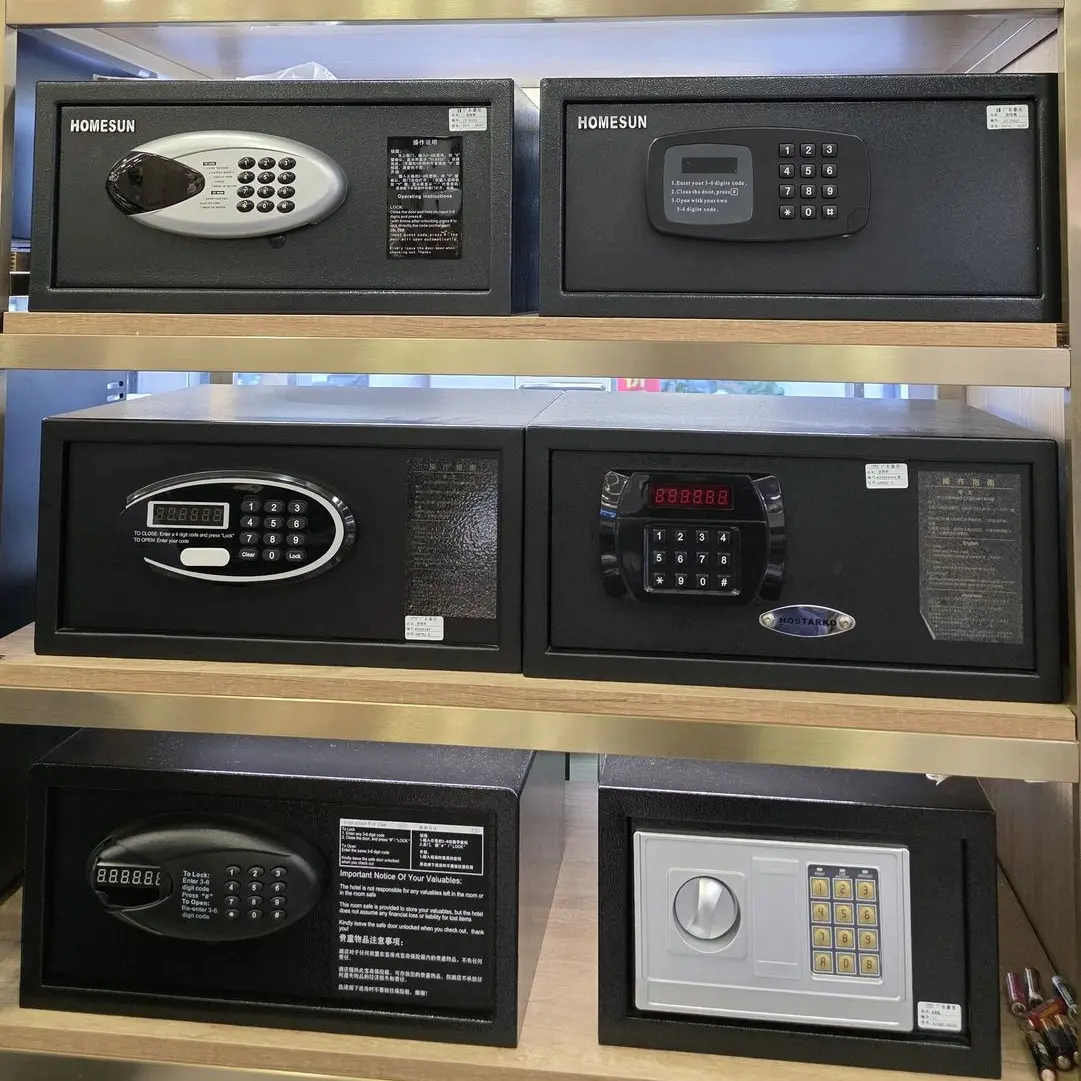 Premium Hotel In-Room Digital Safes - OS&E China Hospitality Supplies Selection of black and silver electronic hotel room safes from OS&E China displayed on showroom shelves.