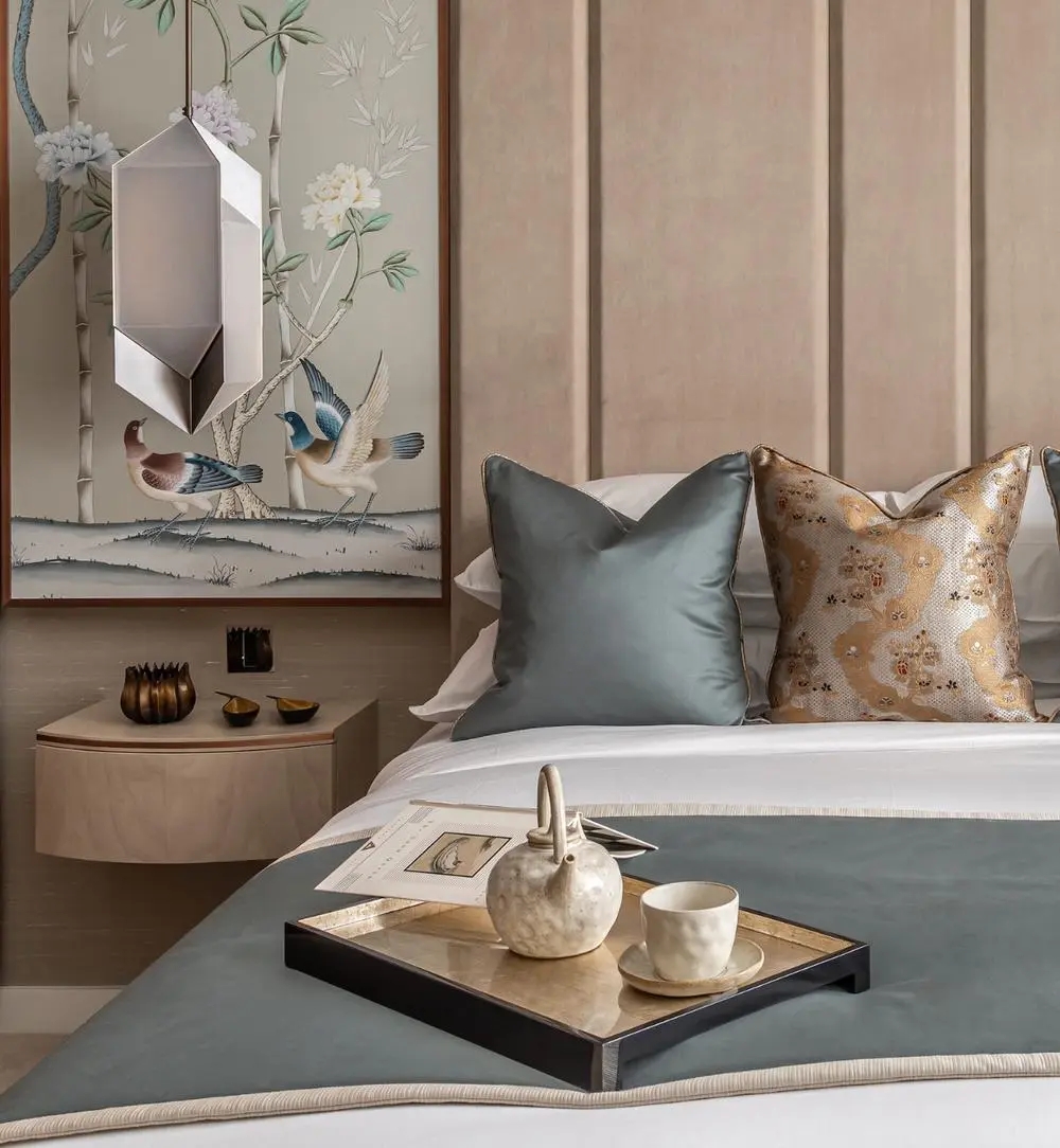 Elegant Guest Room Decor with Chinoiserie Art and Teal Accents Elegant guest room decor featuring a floating nightstand, geometric pendant light, Chinoiserie bird artwork, and a bed dressed with a teal runner and decorative pillows