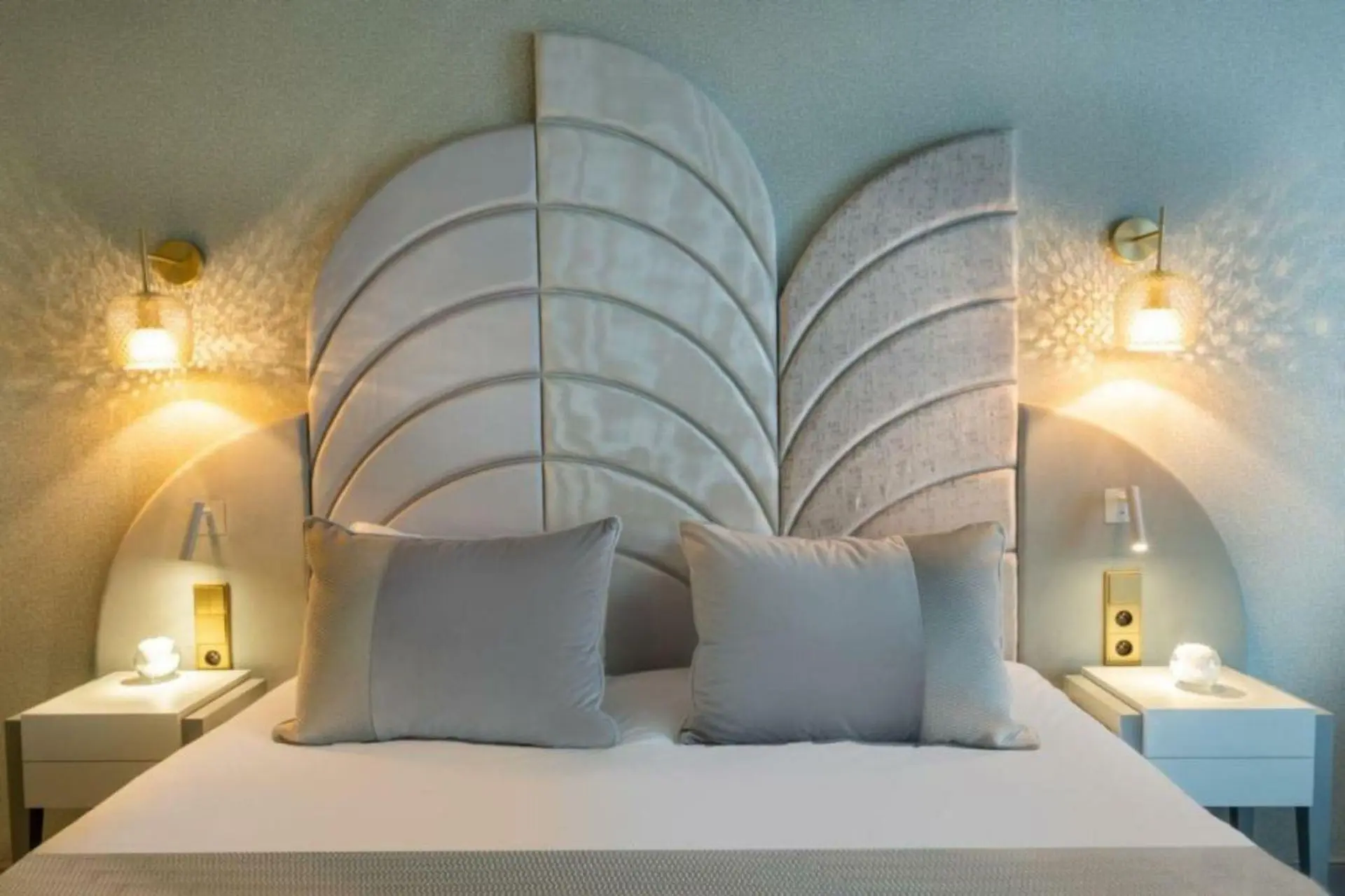 Artistic Leaf-Shaped Upholstered Chinese Headboard Design Modern leaf-shaped upholstered Chinese headboard with segmented panels and bedside wall sconces