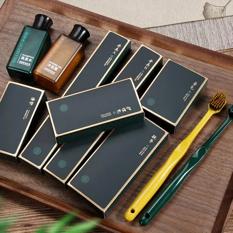 Premium Hotel Room Toiletries & Branded Packaging Set Assorted hotel room toiletries featuring shampoo, shower gel, branded amenity boxes, and toothbrushes arranged on a wooden tray