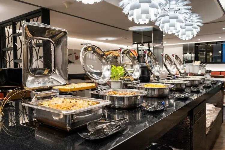 Premium Buffet Equipment China Chafing Dishes Professional stainless steel buffet equipment China setup featuring open chafing dishes on a restaurant serving counter.