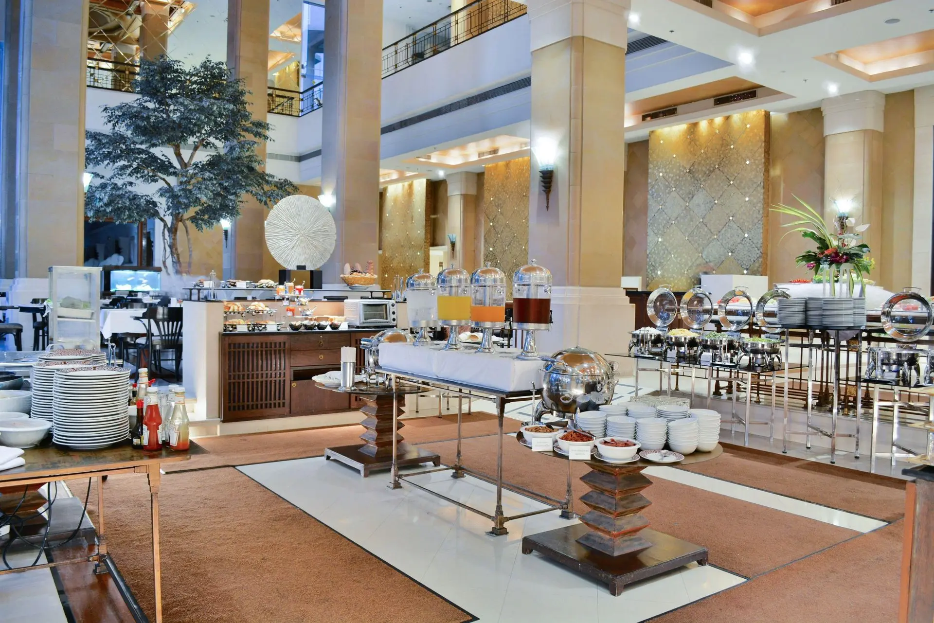 Commercial Hotel Buffet Equipment China Solutions Commercial hotel buffet equipment China setup featuring beverage dispensers and chafing dishes in a spacious dining hall.