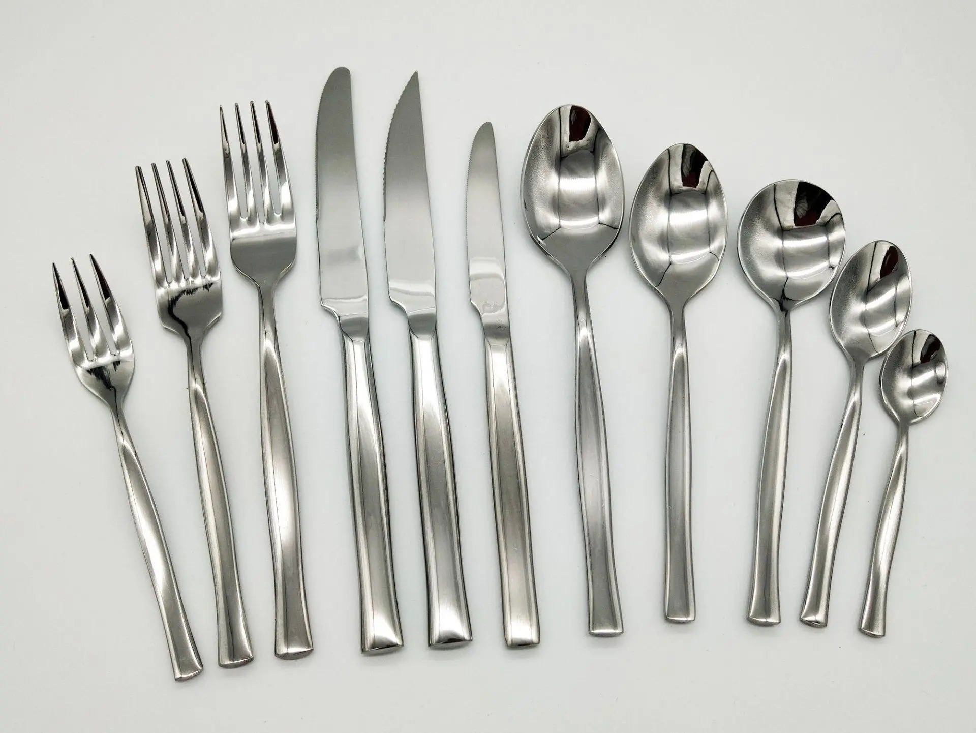 A complete set of stainless steel forks, knives, and spoons displayed alongside hotel glassware China for commercial dining   Meta Description: Upgrade your dining serv